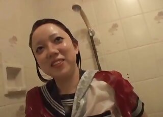 Young Asian chick gets face licked by a pair of black Labradors