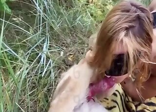 Masked blonde treats her pet dog with a blowjob outdoors
